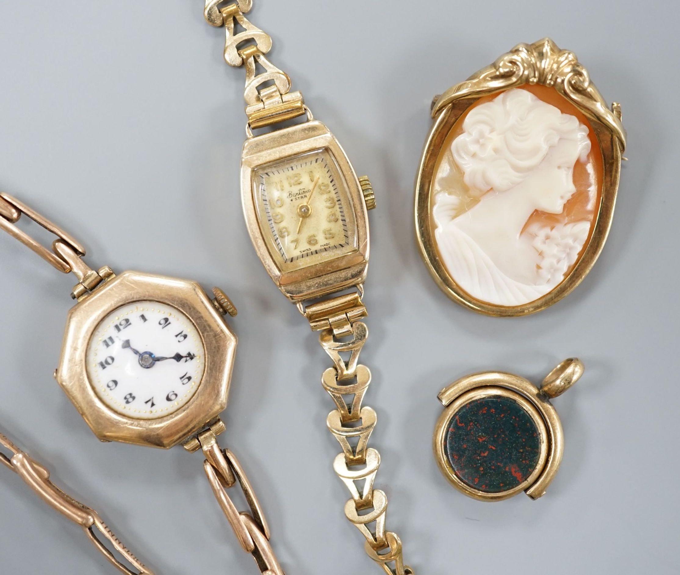 A lady's 9ct gold manual wind wrist watch, on a 9ct expanding bracelet gross 13.6 grams, one other lady's 9ct gold watch on a gold plated bracelet, a modern 9ct gold mounted oval cameo shell brooch and a carnelian and bl